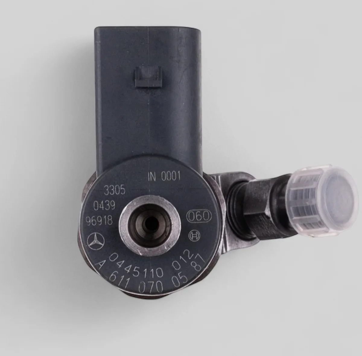 Close-up of Bosch 0445110 012 and Mercedes A 611 070 05 87 part number markings on OM611 family injector
