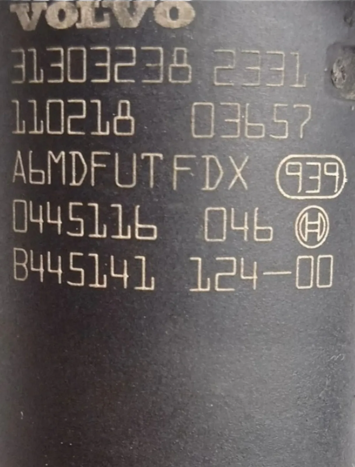 Bosch 0445116046 diesel injector part-number close-up showing 0445116 046 and Volvo 31303238
