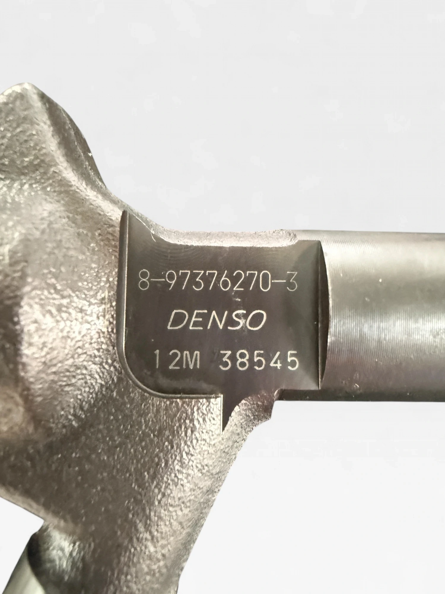 DENSO DCRI106130 part-number close-up showing etched Isuzu OE 8-97376270-3 and DENSO marking